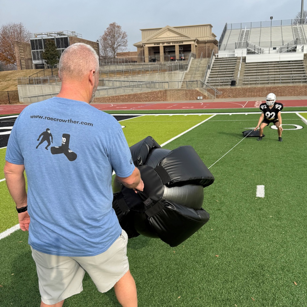 SLING 3 (1) Rae Crowther Sling Ball training tool with stretch tube and 10lb ball for low-impact, fast-moving tackling drills and rip technique practice.